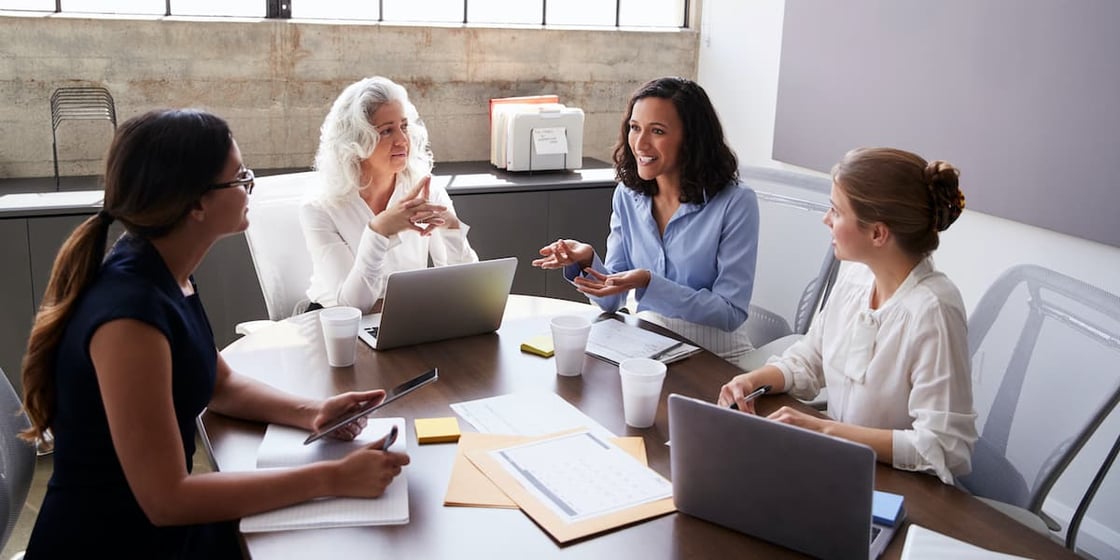 Group of colleagues gathered in a conference room.